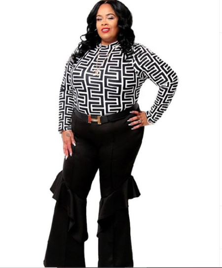 nikkia wearing a black and white stripped top with a black ruffled pants 